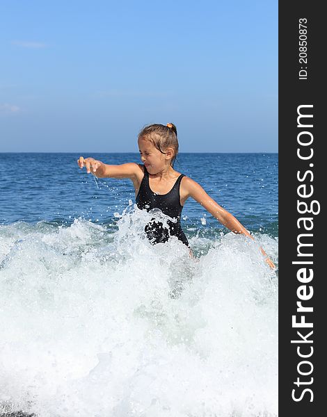 Girl bathes in sea among big waves. Girl bathes in sea among big waves