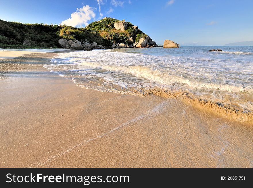 Beach sand on sea coast with rock under sunrise lighting, hown as sea coast physiognomy and landscape. Beach sand on sea coast with rock under sunrise lighting, hown as sea coast physiognomy and landscape.