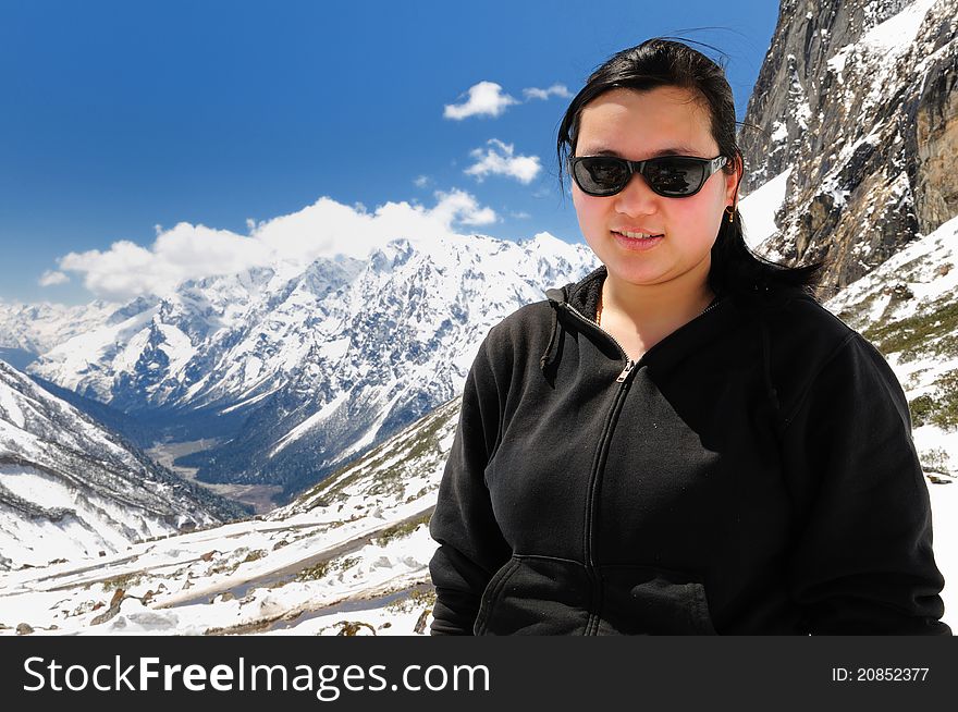 Attractive Sikkimese woman in front of Sikkim landscape at Yumthang valley