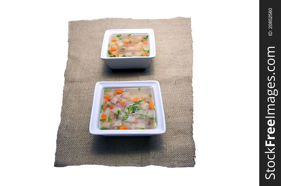 Slightly distorted perspective of two bowls of soup in a studio. Slightly distorted perspective of two bowls of soup in a studio.