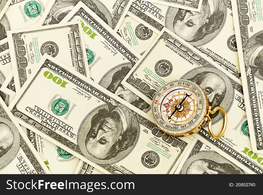 Vintage gold Compass on american money background. Vintage gold Compass on american money background