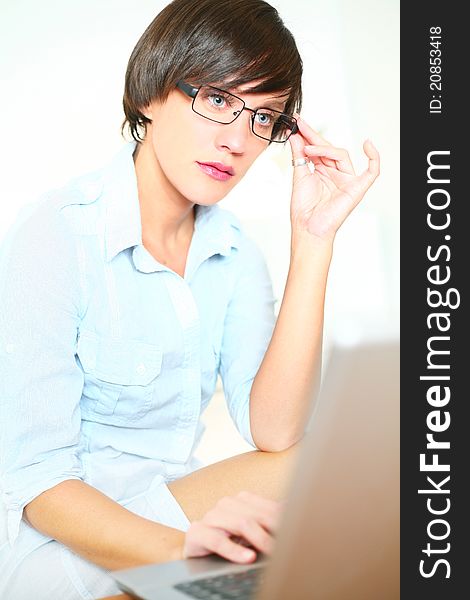 Beautiful girl with glasses working on laptop