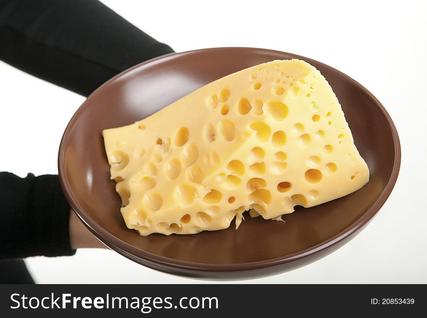 Slice of cheese on a plate, in the hands of a girl. Slice of cheese on a plate, in the hands of a girl