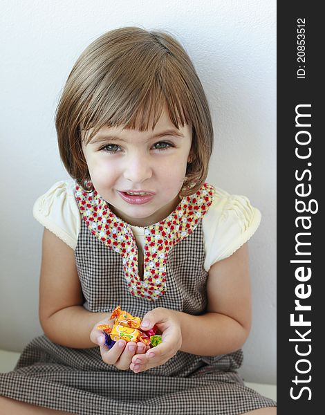 Little girl with candies in her hands