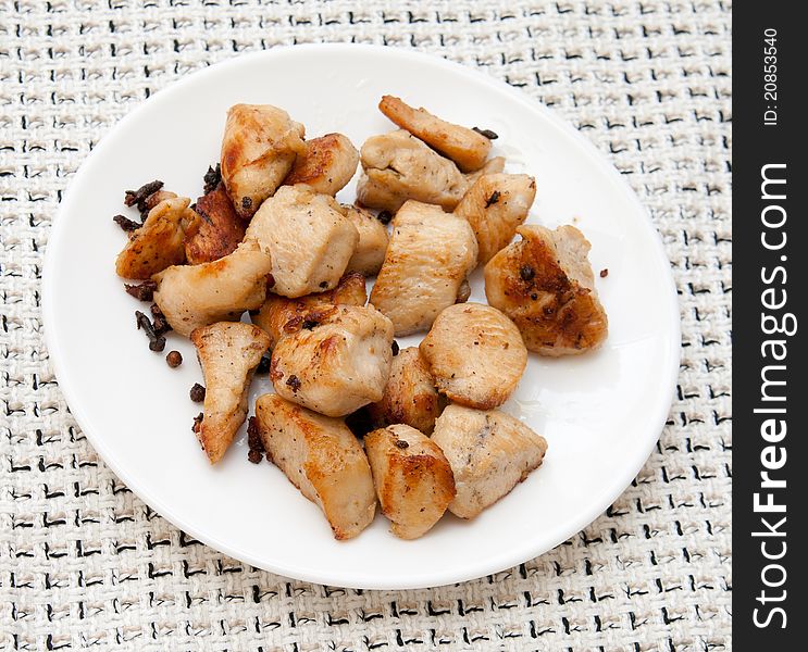 Delicious chicken with potatoes on a white platter