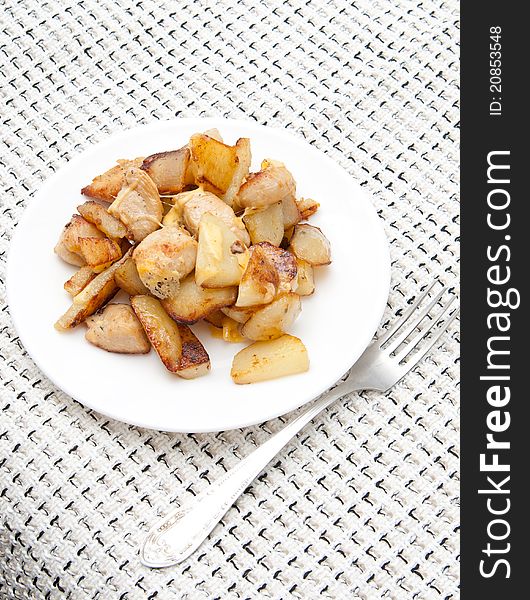 Delicious Chicken With Potatoes On A White Platter