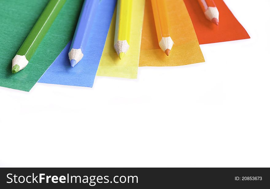 A colorful pencil crayons and scrapbooking papers ready for creative use. A colorful pencil crayons and scrapbooking papers ready for creative use.