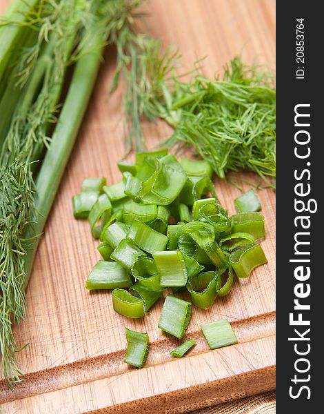 Dill and parsley on chopping board