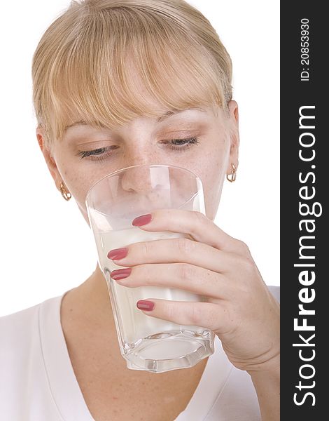 Blonde girl drinking a milk from the glass. Blonde girl drinking a milk from the glass