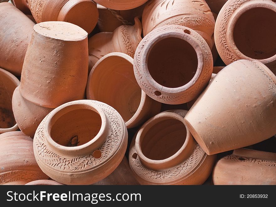 Pile of orange pottery in a factory in Bangkok, Thailand