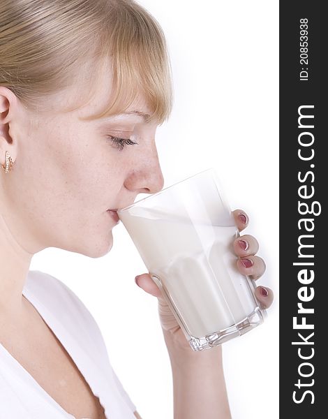 Blonde girl drinking a milk from the glass. Blonde girl drinking a milk from the glass