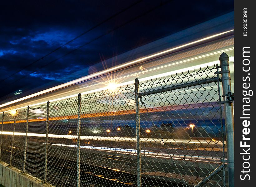 Denver Colorado's Municipal Light Rail Speeding southbound on Interstate 25. Denver Colorado's Municipal Light Rail Speeding southbound on Interstate 25.