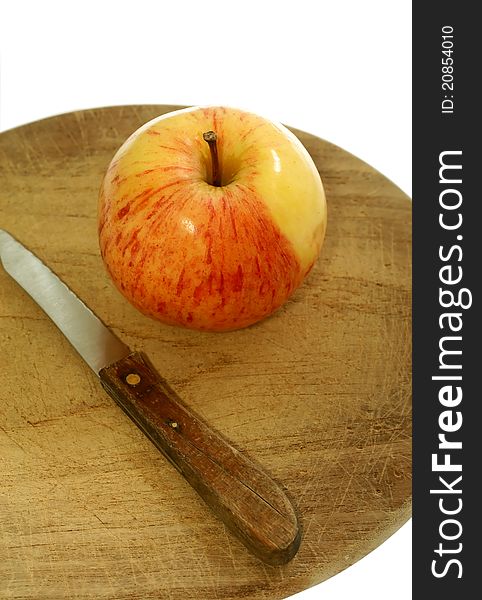 Apple and knife on kitchen board isolated on white background