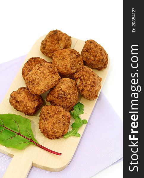 Meatballs on kitchen board isolated on white background
