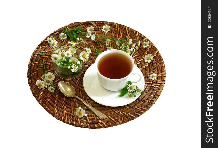 Cup of tea and chamomiles isolated on white background