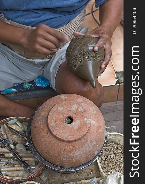 A skilled craftsmanmaking a pottery in Thailand. A skilled craftsmanmaking a pottery in Thailand.