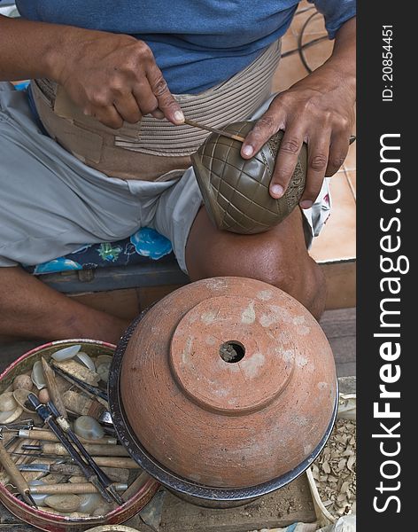 A skilled craftsmanmaking a pottery in Thailand. A skilled craftsmanmaking a pottery in Thailand.