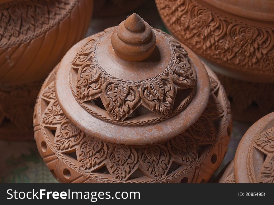 Pile of orange pottery in a factory in Bangkok, Thailand