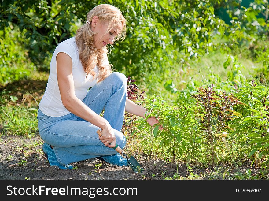 A young active woman in the garden. A young active woman in the garden