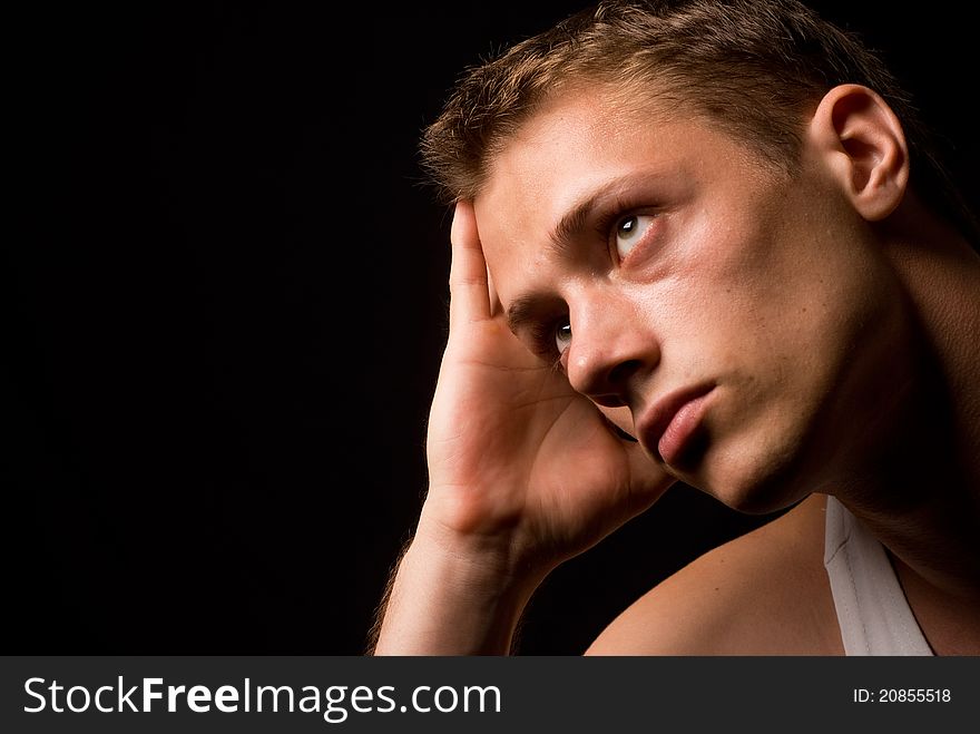 Portrait of a cute guy on a black background. Portrait of a cute guy on a black background