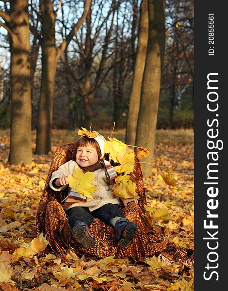 Little boy in a chair outdoors