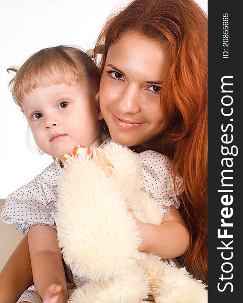 Cute mom and her daughter on a white. Cute mom and her daughter on a white