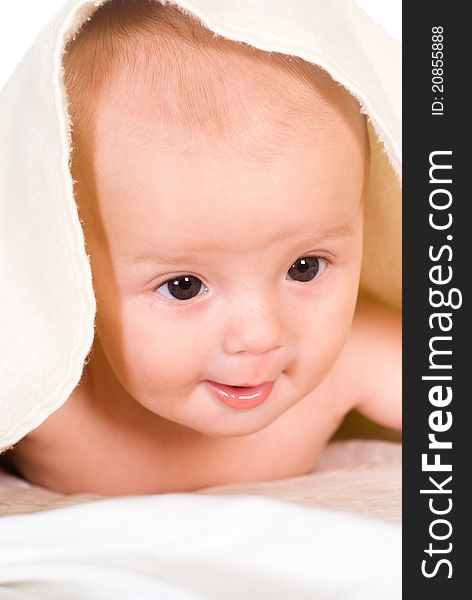 Cute baby lying under the towel on white. Cute baby lying under the towel on white