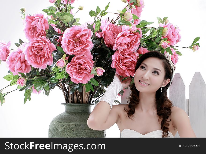 Portrait of young beautiful girl with flower on white background