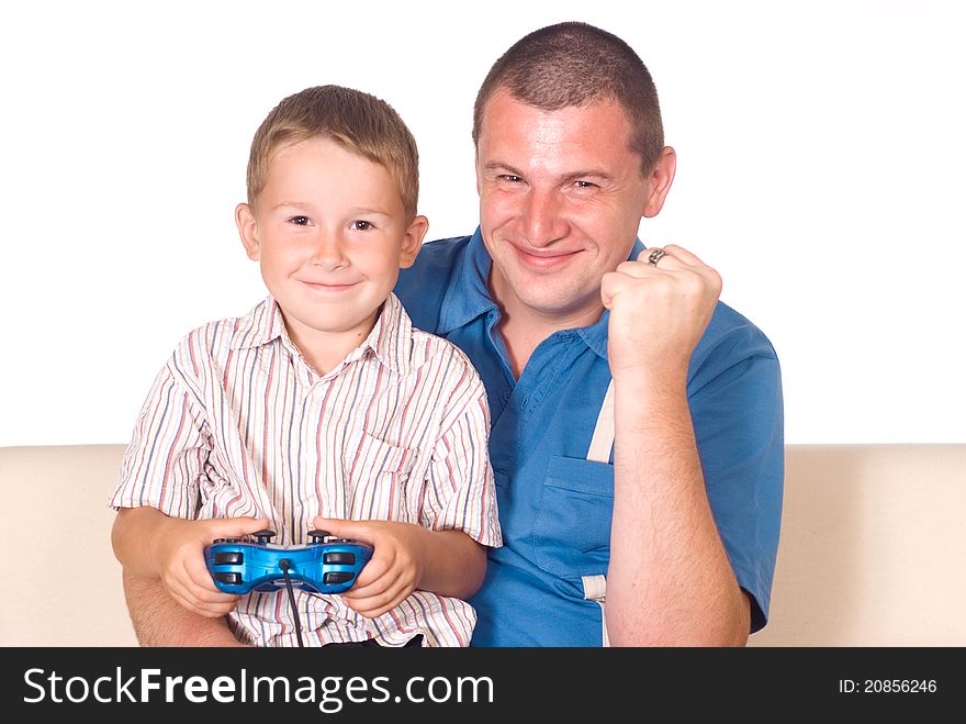 Dad with his son playing games on sofa. Dad with his son playing games on sofa