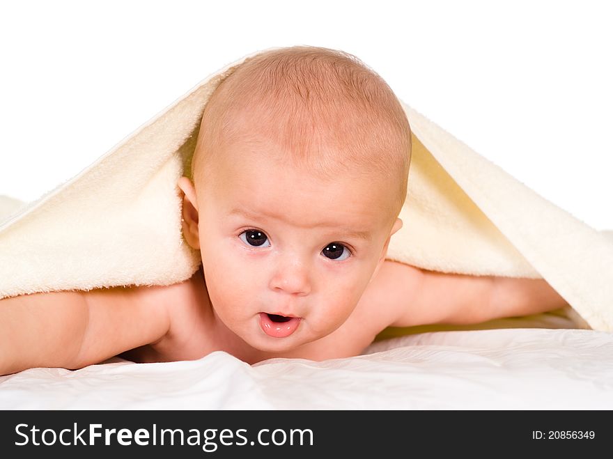 Cute baby lying under the towel on white. Cute baby lying under the towel on white