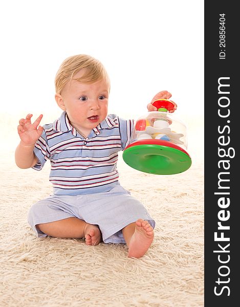 Little boy playing on a carpet on white. Little boy playing on a carpet on white