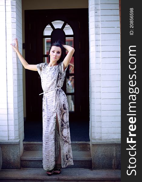 A beautiful young woman in evening dress standing in the hallway