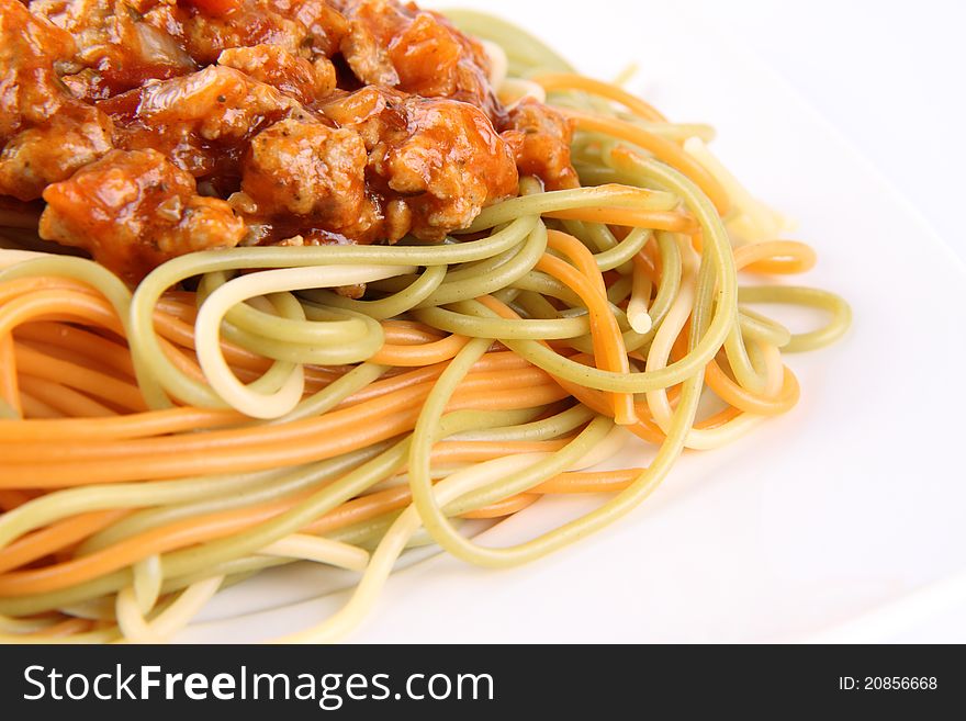 Colorful Spaghetti bolognese on a plate in close up