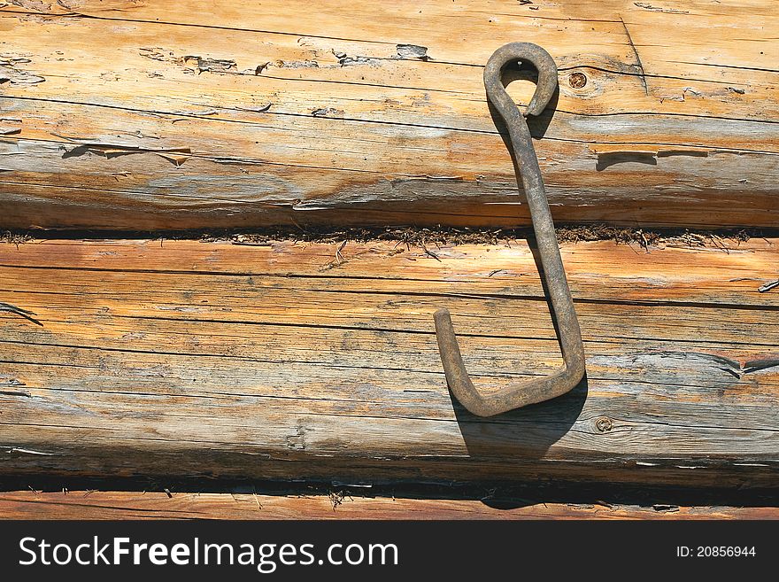 Fragment of wooden frame wall with an iron hook. Texture, background. Fragment of wooden frame wall with an iron hook. Texture, background