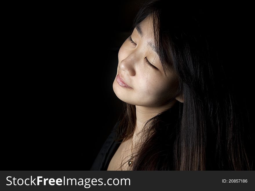 A young girl with a sensual expression on her face.