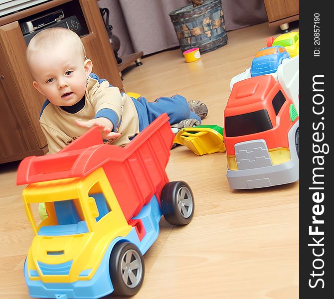 One year boy playing with trucks. One year boy playing with trucks