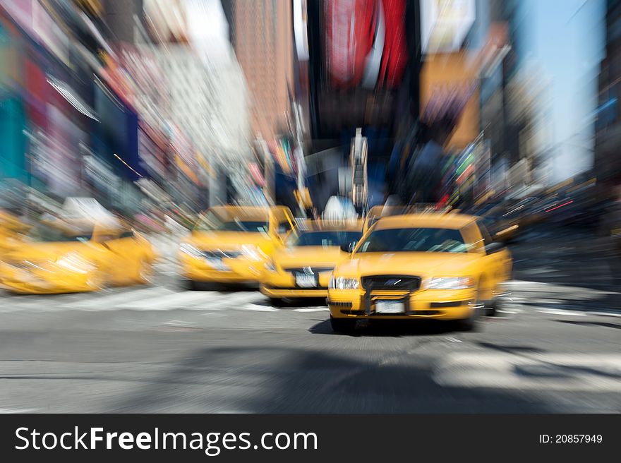 Abstract motion blur of a city street scene with a yellow taxi cabs speeding. Abstract motion blur of a city street scene with a yellow taxi cabs speeding