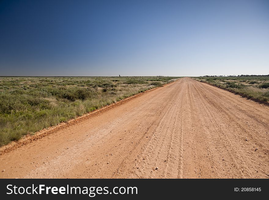 Unsealed country road in Australia stretching off to he horizon. Unsealed country road in Australia stretching off to he horizon