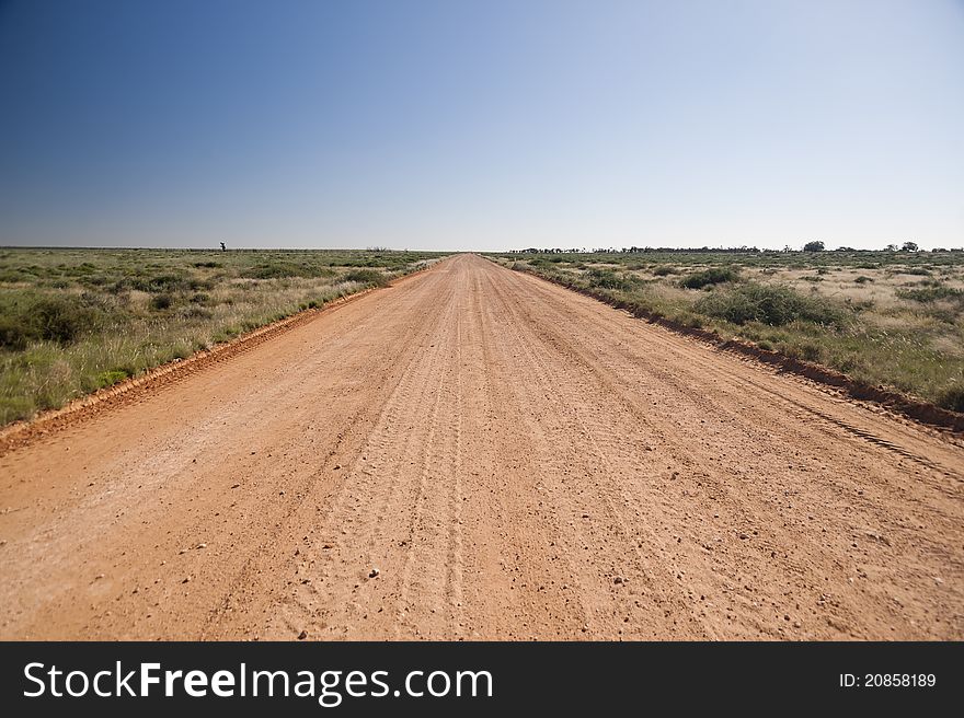 Unsealed country road in Australia stretching off to he horizon. Unsealed country road in Australia stretching off to he horizon