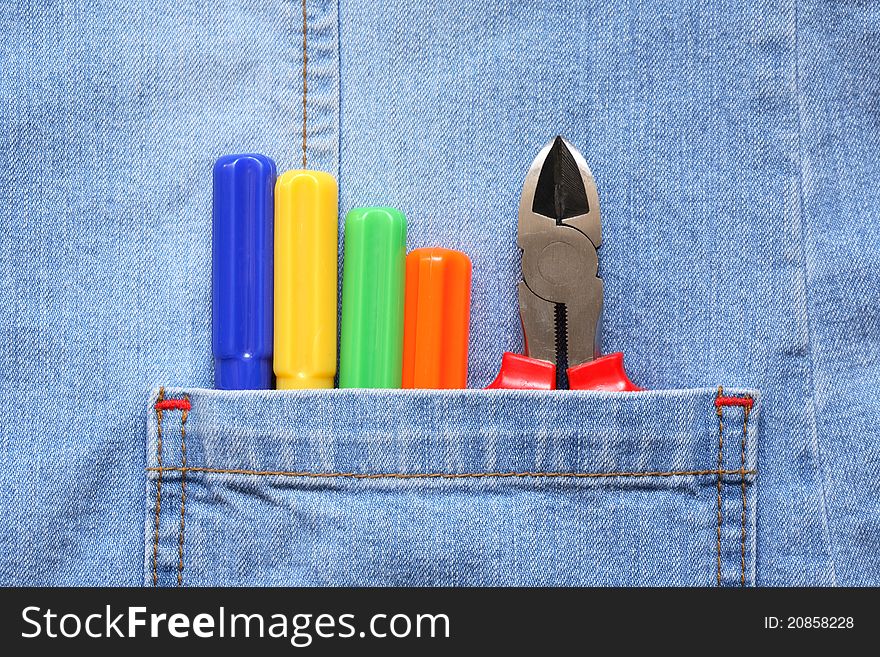 Closeup of denim pocket with color work tools. Closeup of denim pocket with color work tools
