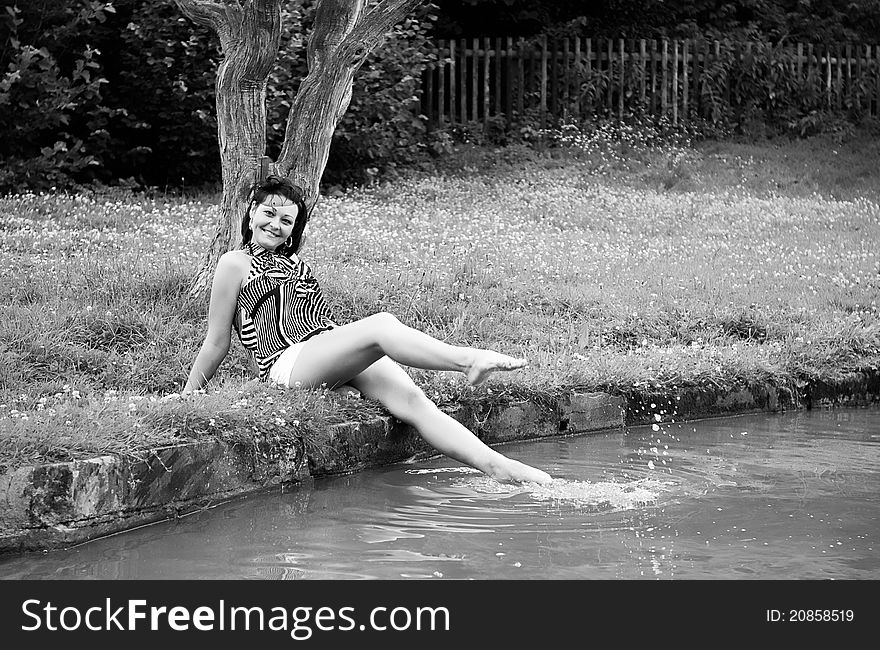 The girl on a grass at lake