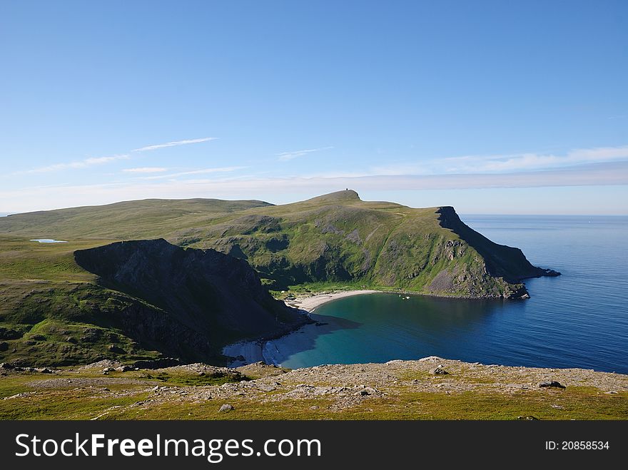 Soroya is a large island in western Finnmark of Norway. There are blue bays, steep hills overgrown with moss and famous sand beaches. Soroya is a large island in western Finnmark of Norway. There are blue bays, steep hills overgrown with moss and famous sand beaches.