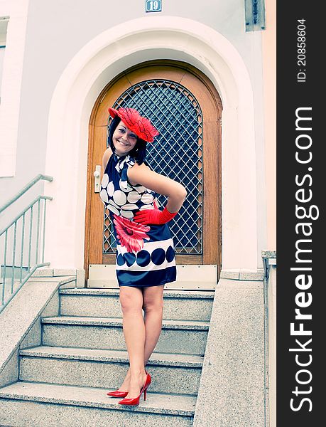 The girl in a hat in an old city in a province