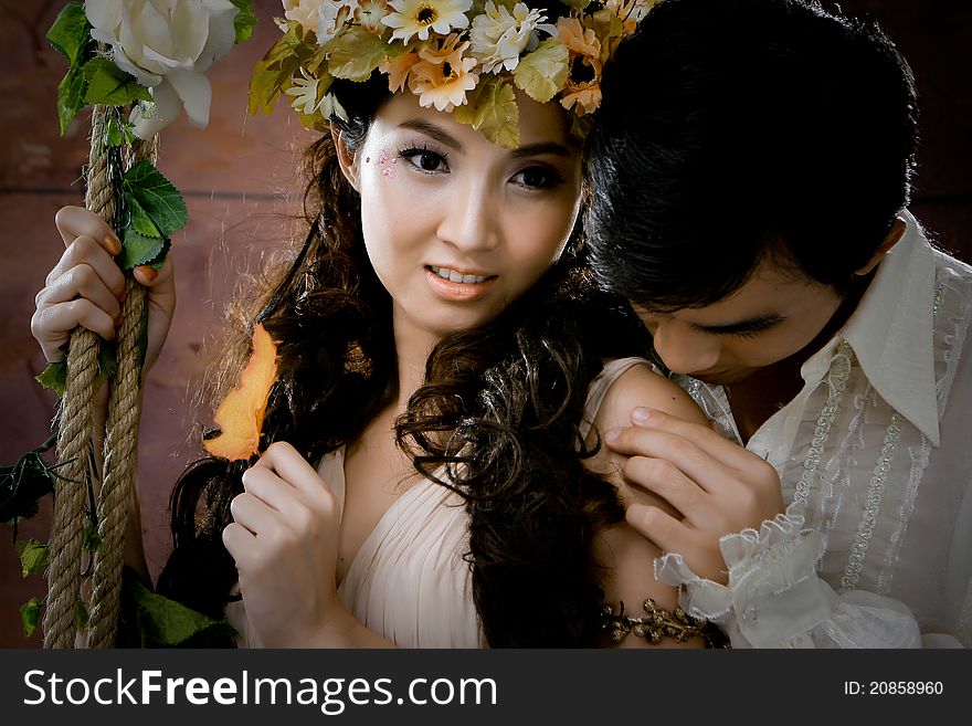 Portrait of young couple in antique dress with erotic emotion