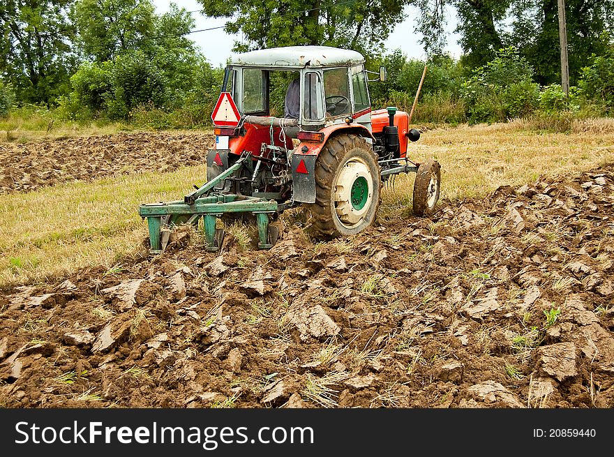 Ploughing field on old tractor in southern Poland