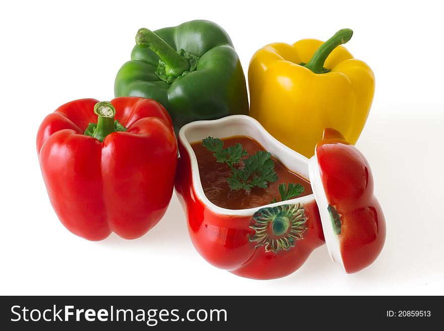 Colorful bell peppers with red ceramic ornament