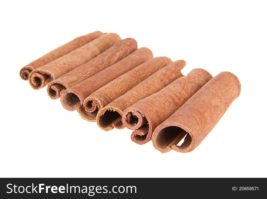 The sticks of cinnamon lying on a white isolated background