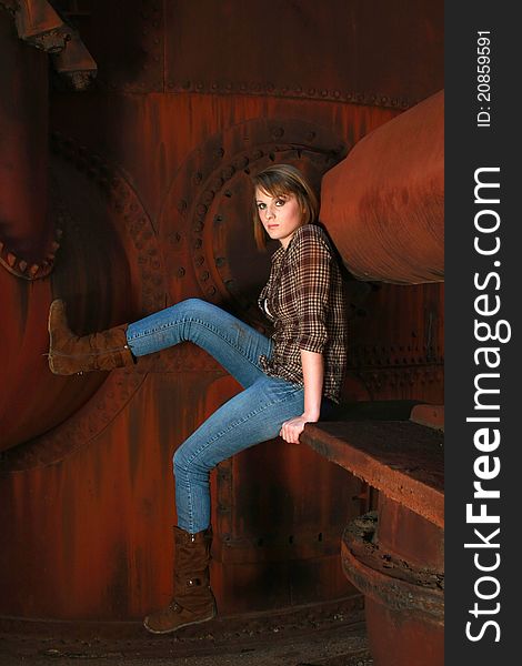 Young Woman Against Old Rusty Metal