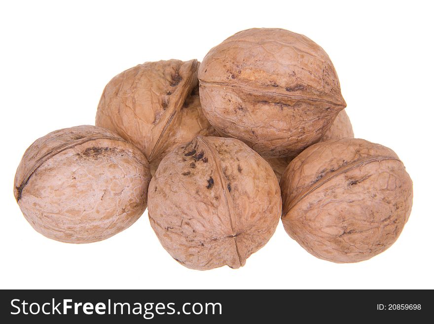 The group of walnuts lying on a white isolated background