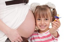 Pregnant Woman With Her Daughter Stock Images
